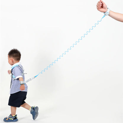 Toddler wearing blue anti-lost safety harness with 2m spring leash wrist strap in use.