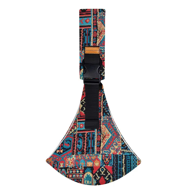 Colorful patterned adjustable baby carrier wrap with buckle and strap flat lay.