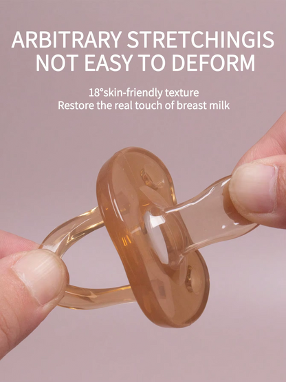 Light brown silicone baby pacifier being stretched to show flexible, skin-friendly nipple design.