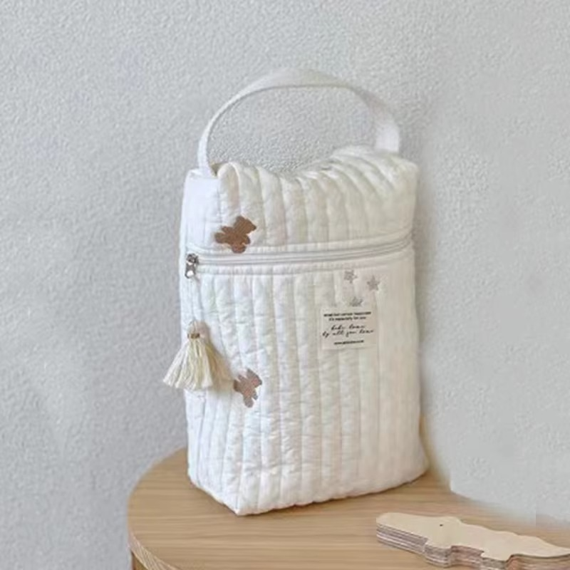 Quilted Diaper Caddy Bag Snowflake variant flat on white textured surface with wooden star wand.