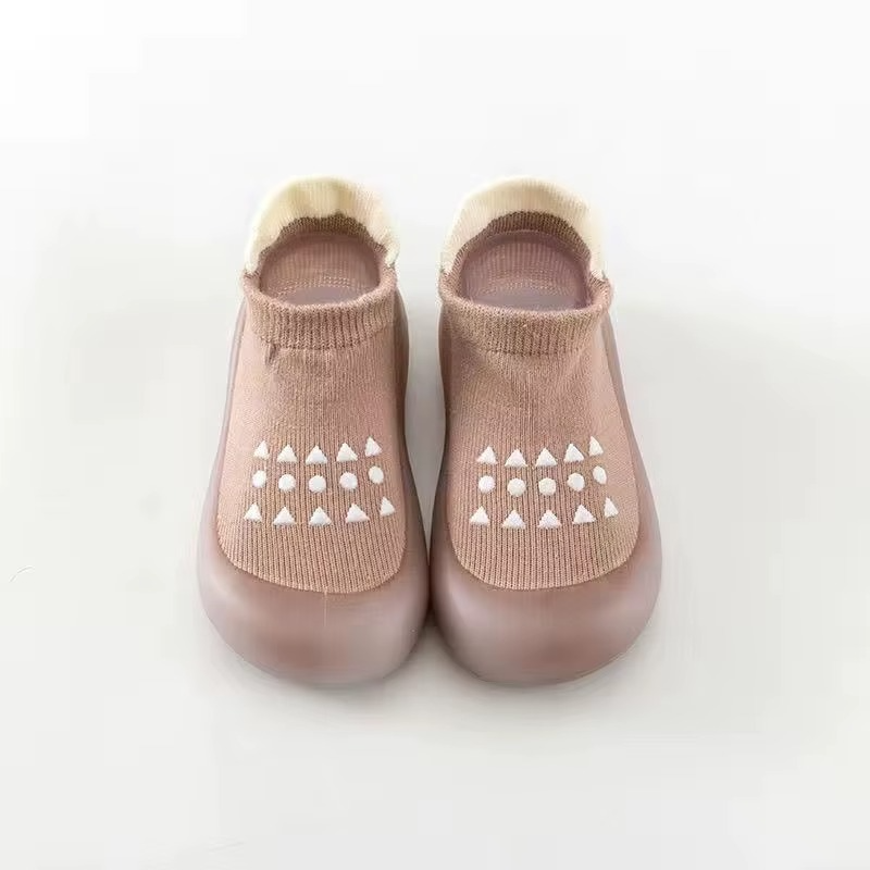 Coffee breathable baby walking shoes with soft sole and white anti-slip pattern front view.