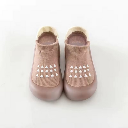Coffee breathable baby walking shoes with soft sole and white anti-slip pattern front view.