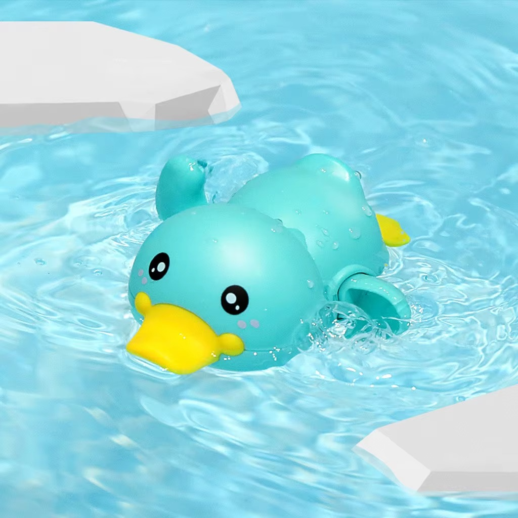 Baby Clockwork Bath Toy green duck swimming in water with yellow beak.