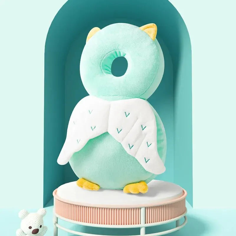 Mint Owl baby head protection pillow backpack with white wings and yellow feet, back view.