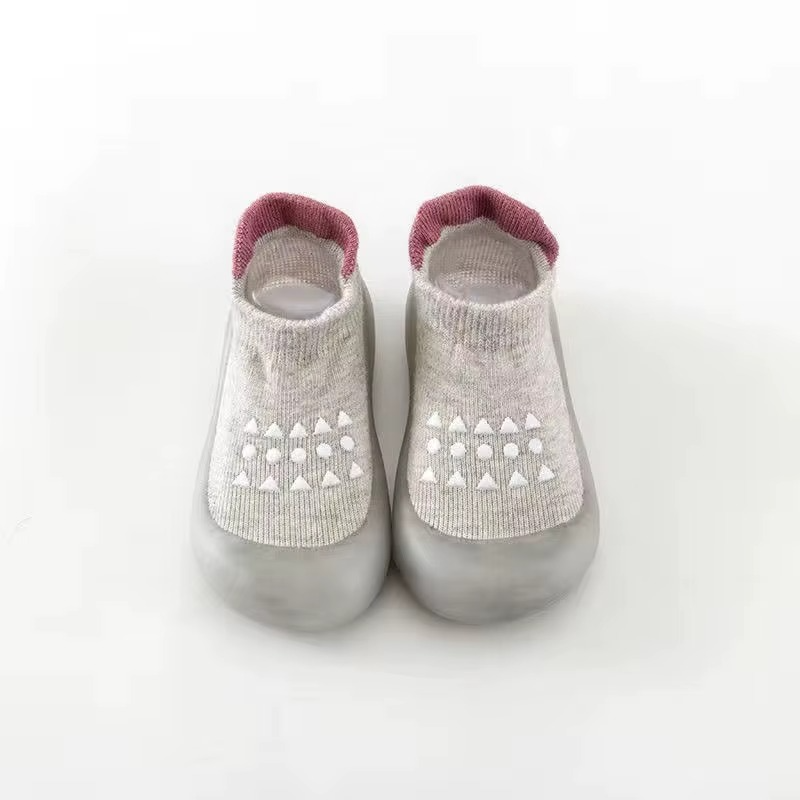 Grey breathable baby walking shoes with soft sole and white anti-slip pattern front view.