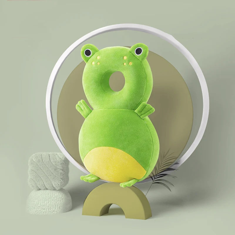 Green Frog baby head protection pillow backpack with yellow belly and small arms, back view.