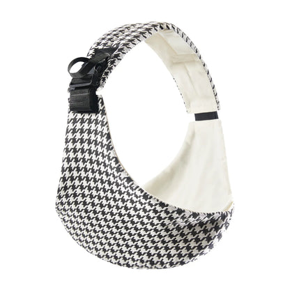 Black and white houndstooth adjustable baby carrier wrap curved with white interior lining.