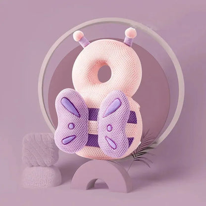 Pink butterfly baby head protection pillow backpack with mesh wings on purple background.