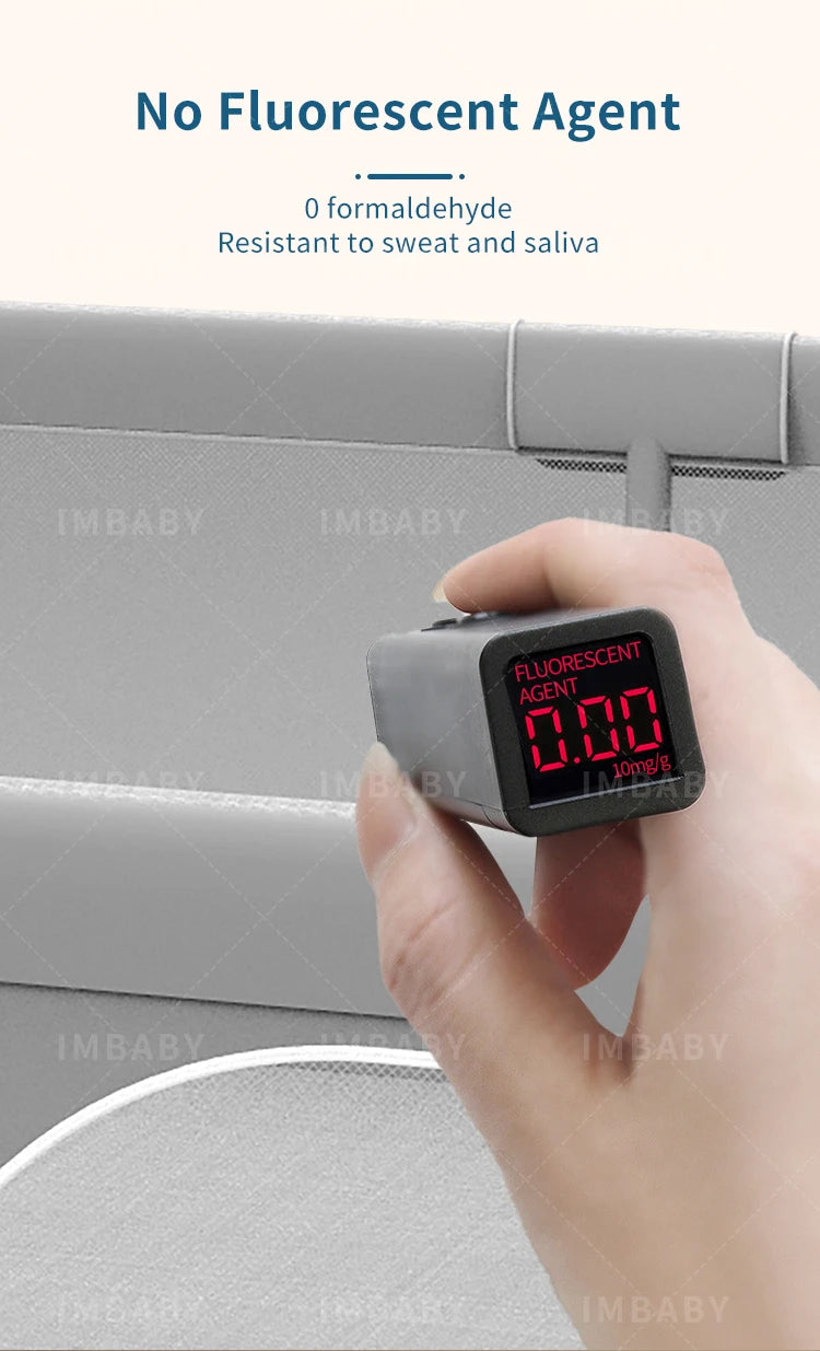Fluorescent agent tester showing zero on gray baby playpen fabric.