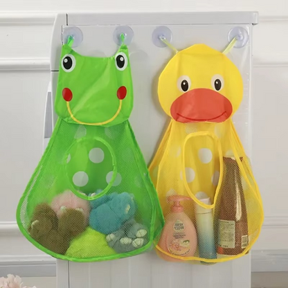 Green frog and yellow duck bath toy storage mesh bags hanging on suction cups on cabinet door.