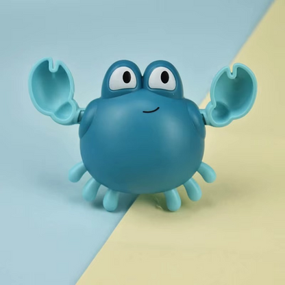 Blue crab wind-up bath toy with raised claws and smiling face on two-tone background.