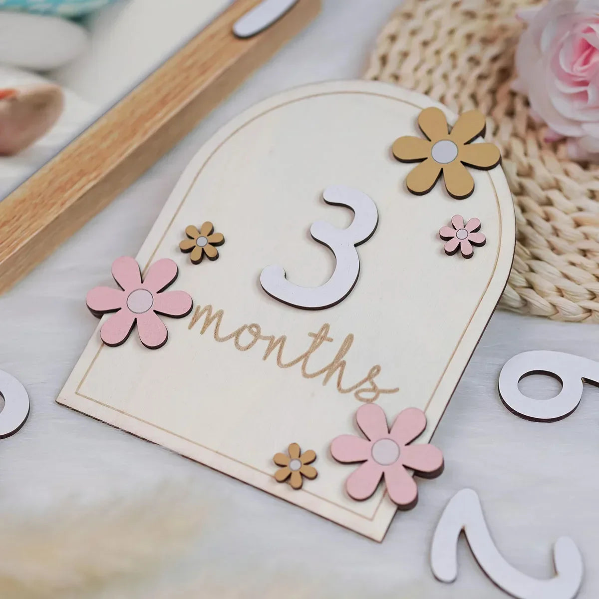 Wooden baby milestone card number 3 with pink and yellow flowers for monthly photo props.