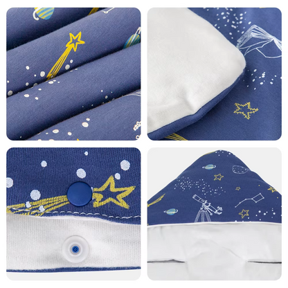 Close-up details of blue space print fabric, white lining, snap button, and hood of baby wrap blanket.
