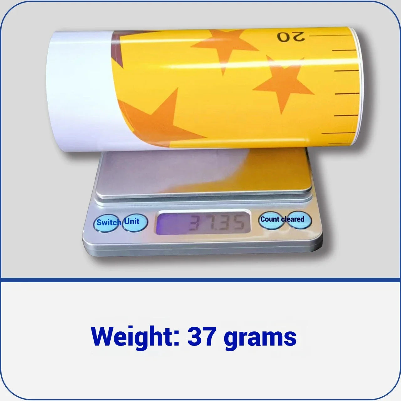 Rolled yellow giraffe growth chart decal on scale showing 37 grams weight.