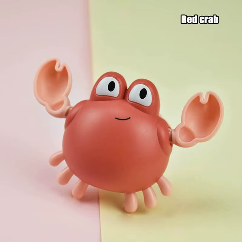 Baby Clockwork Bath Toy red crab with light pink claws and smiling face.
