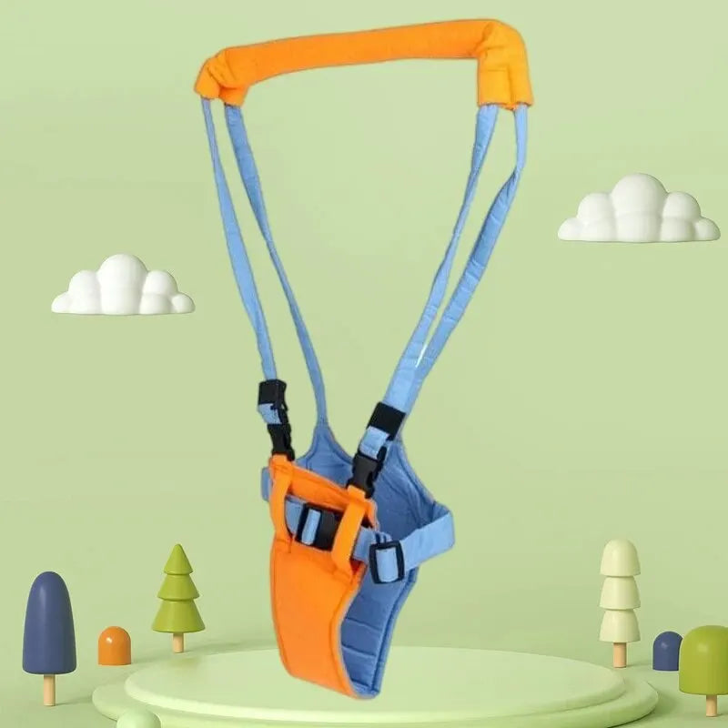 Orange and blue baby walking harness assistant displayed on green platform with toy trees and clouds backdrop.