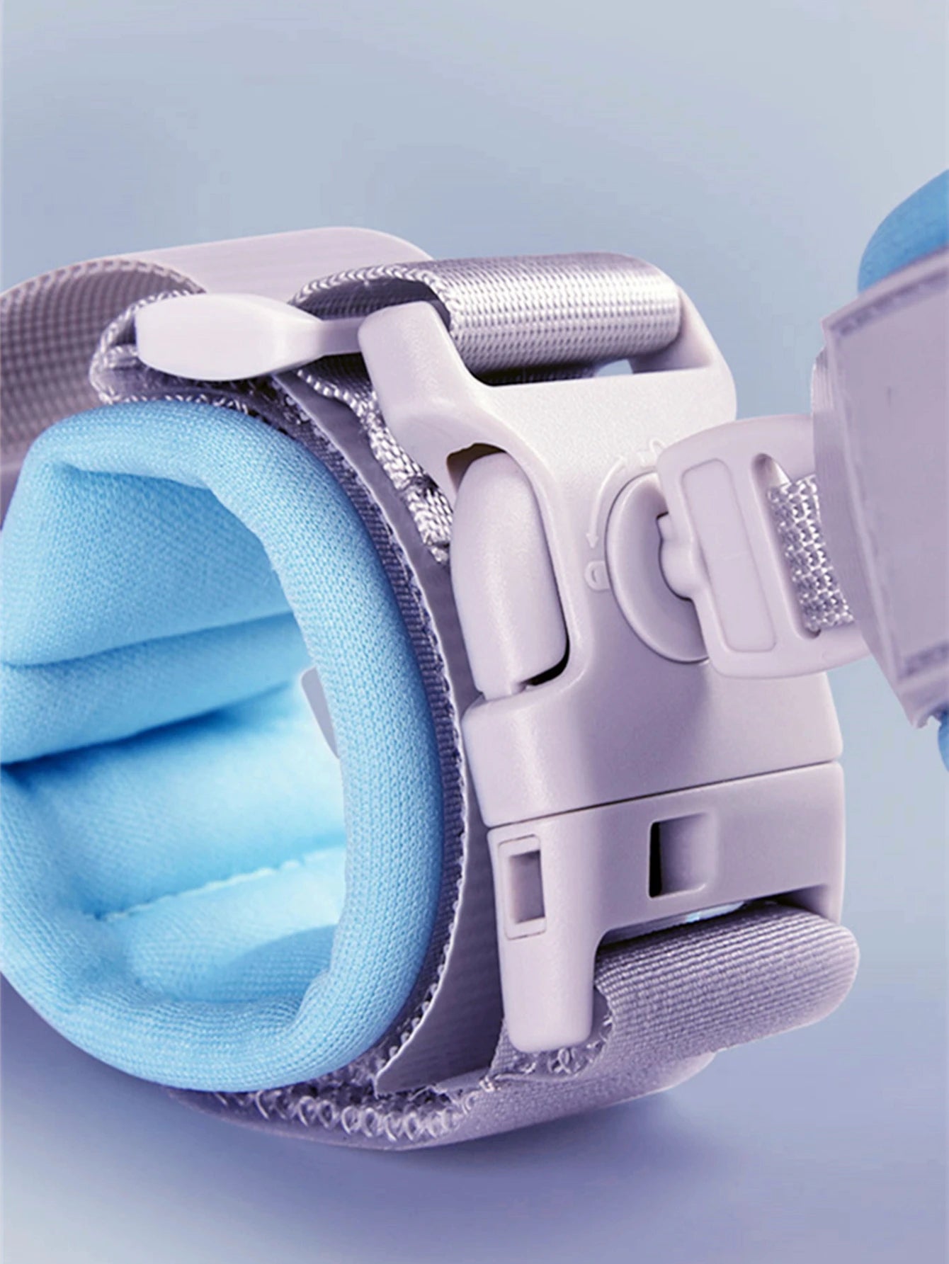 Blue padded wrist strap with secure buckle and adjustable gray strap.