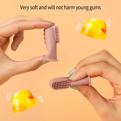 Hands showing flexibility of dark pink baby silicone finger toothbrush for gentle gum care.