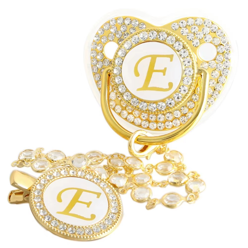 Personalized white and gold baby pacifier with letter E and crystal clip chain.