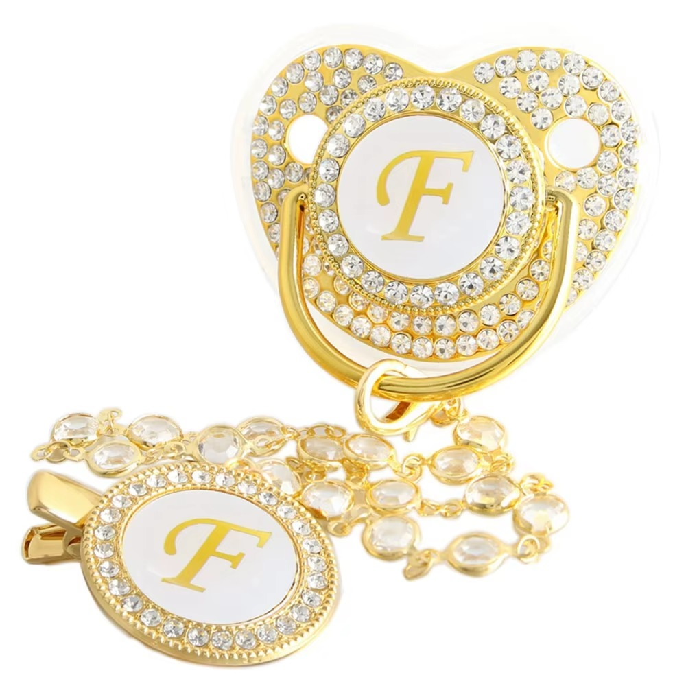 Personalized white and gold baby pacifier with letter F and crystal clip chain.