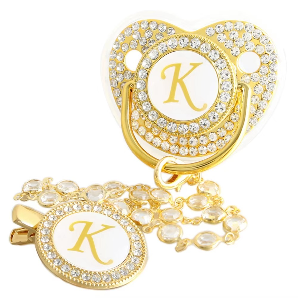 Personalized baby pacifier and crystal clip chain with gold letter K initial.