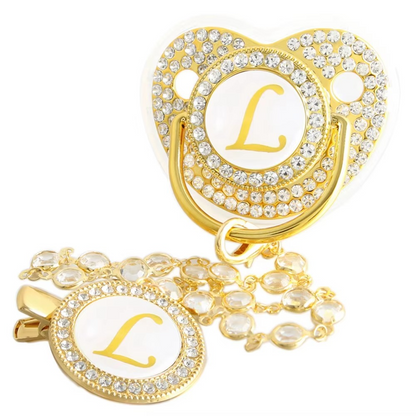 Personalized baby pacifier and crystal clip chain with gold letter L initial.