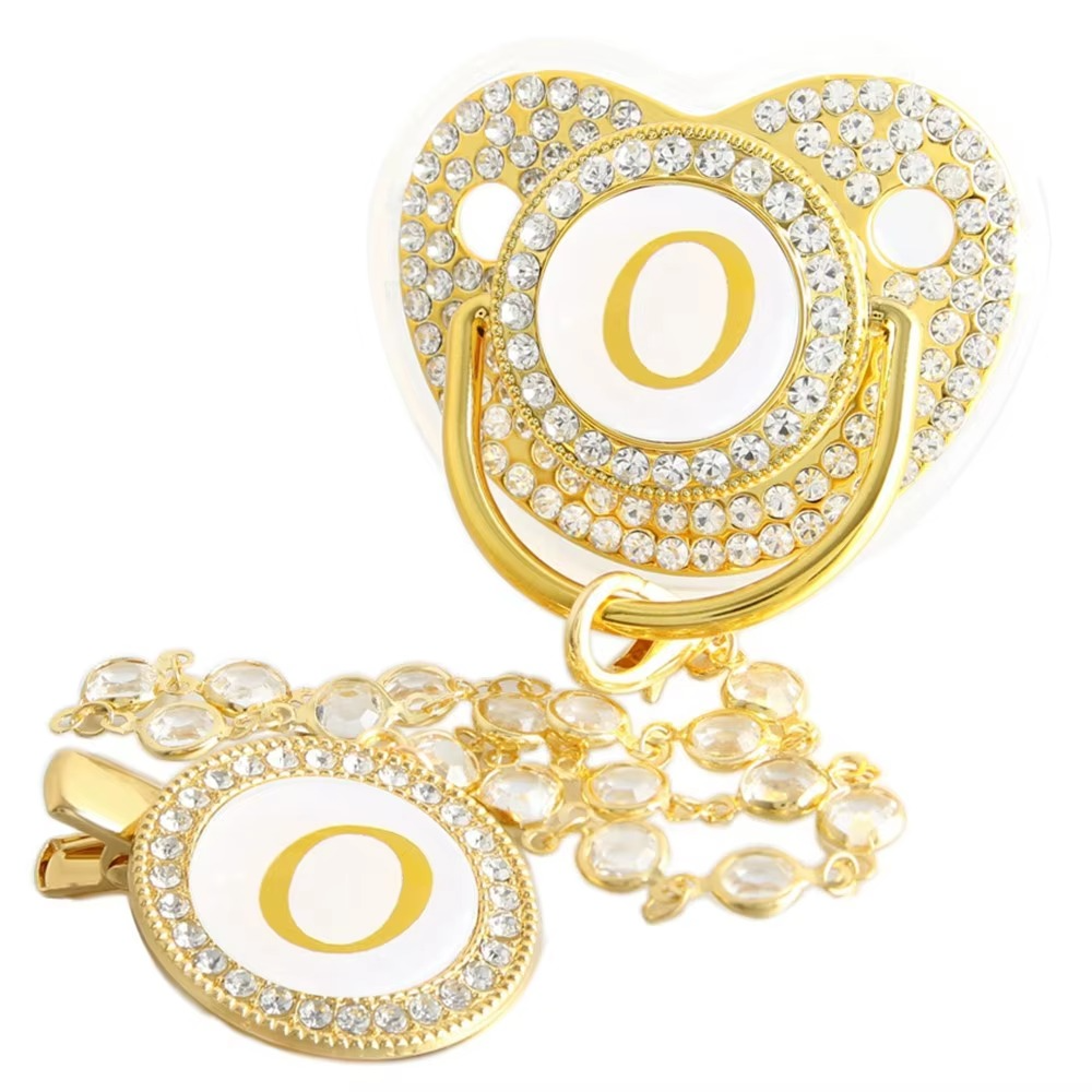 Personalized baby pacifier and crystal clip chain with gold letter O initial.