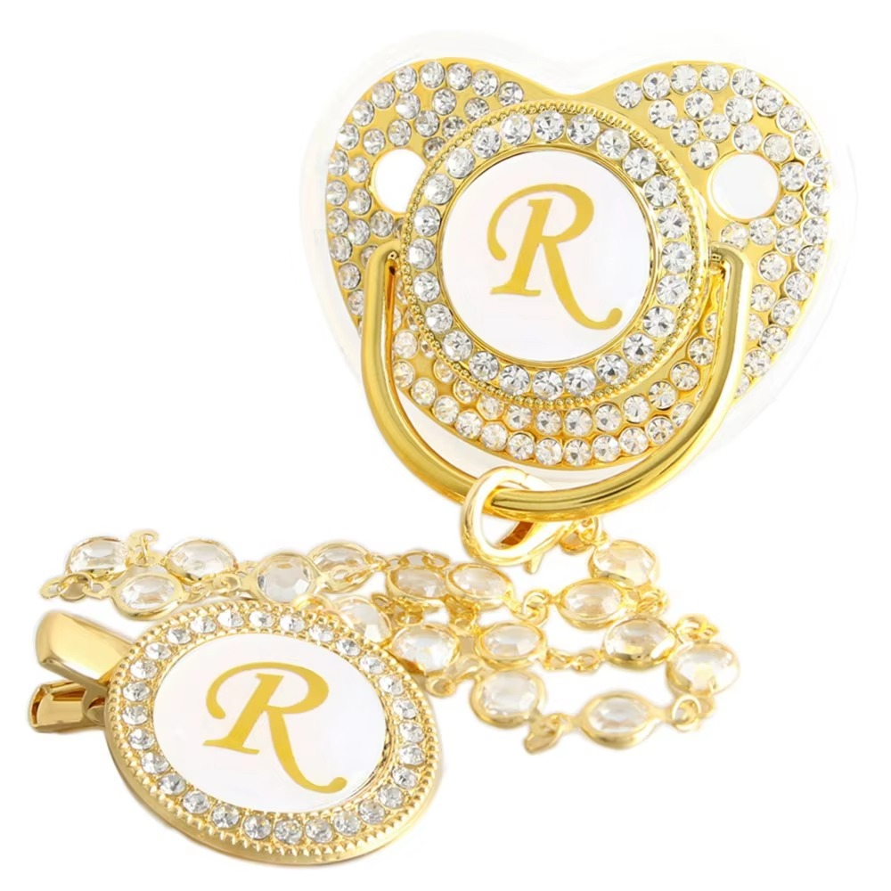 Personalized gold baby pacifier and crystal clip chain with letter R initial.