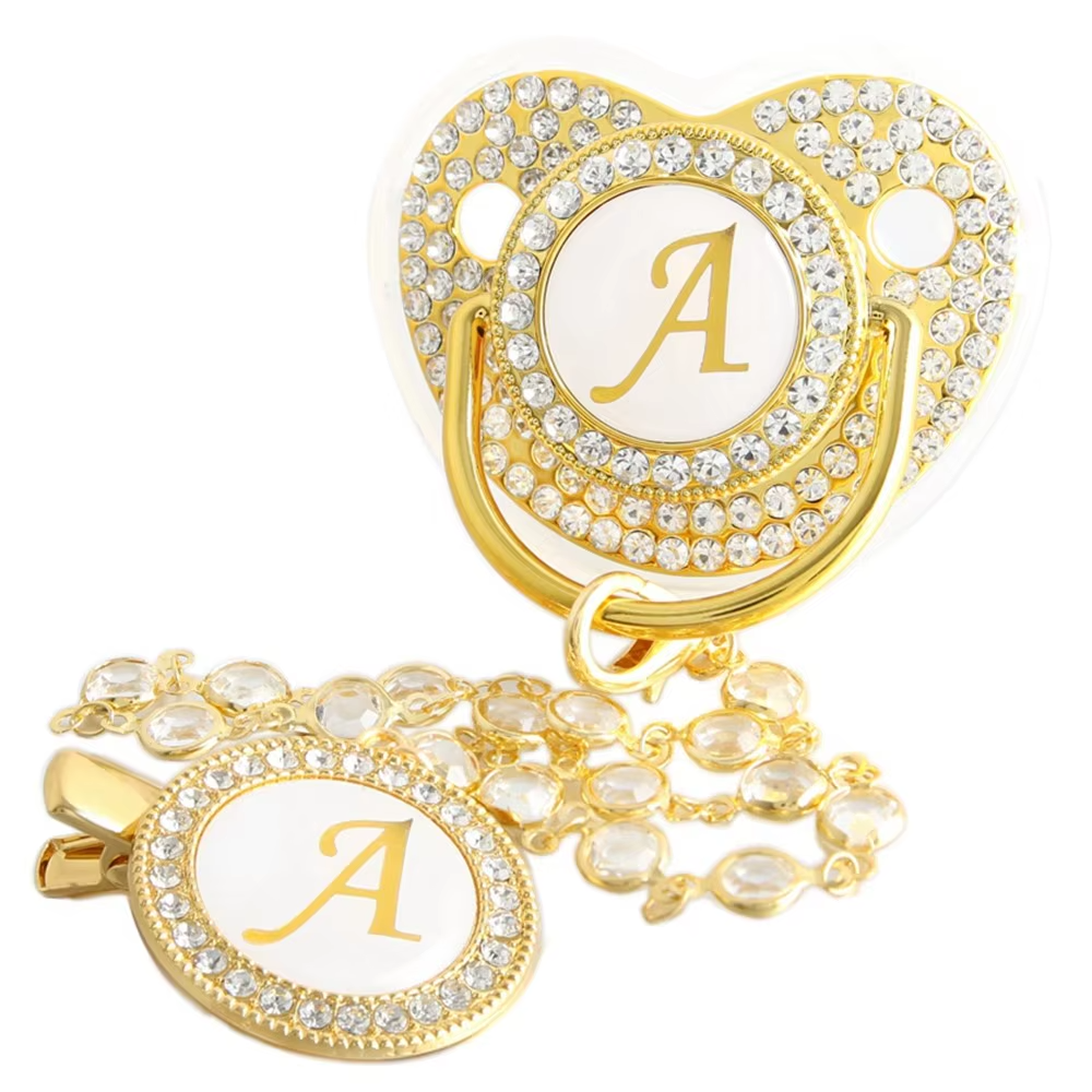 Personalized baby pacifier and crystal clip chain with gold letter A initial.