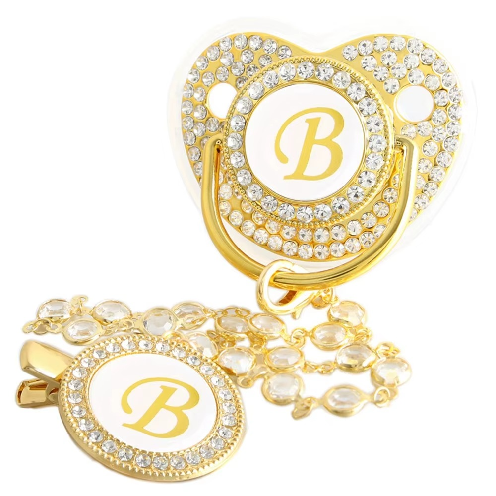 Personalized white and gold baby pacifier with letter B and crystal clip chain.