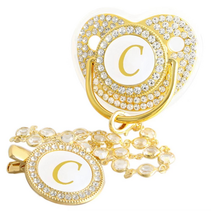 Personalized white and gold baby pacifier with letter C and crystal clip chain.