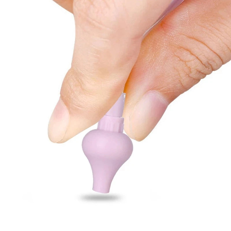 Hand holding pink silicone tip of baby nasal aspirator showing soft flexible material.