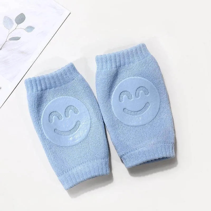 Blue Comfort Crawl baby knee pads with smiley grip pads for crawling support.