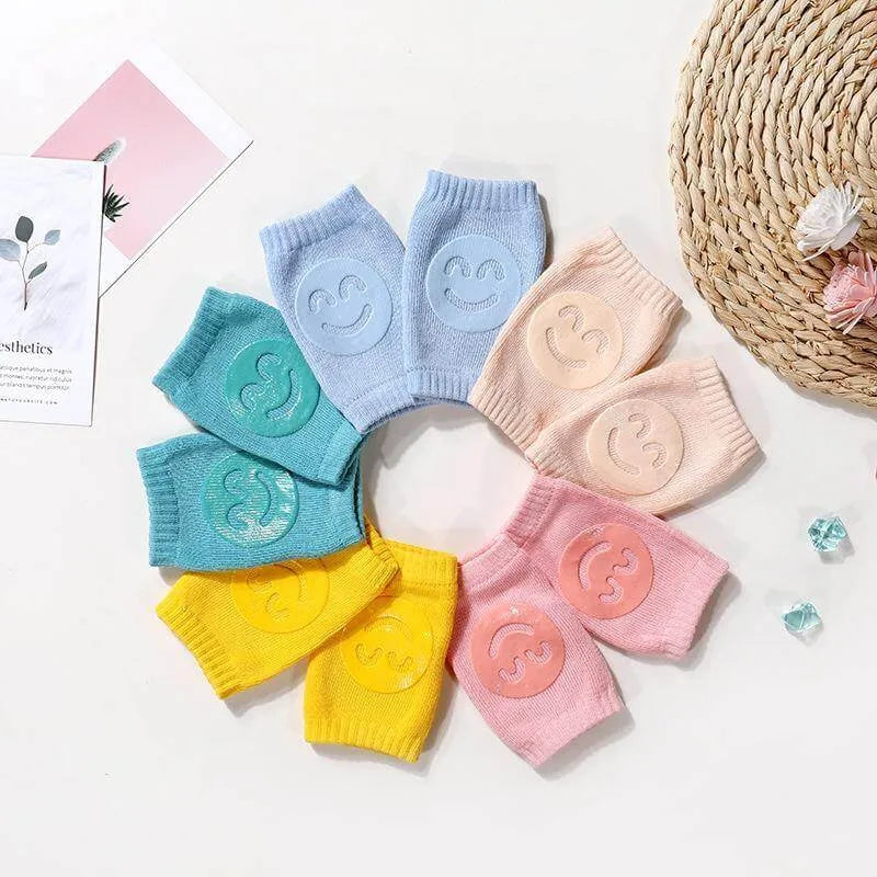 Set of five Comfort Crawl baby knee pads in multiple colors arranged in a circle.