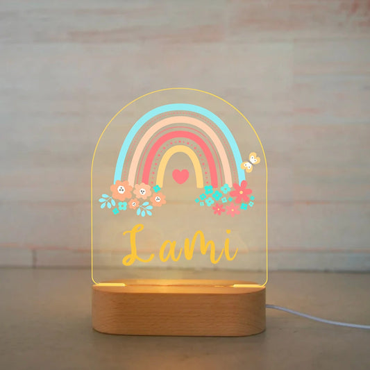 Personalized rainbow and flower LED baby night light with name Lami on wooden base.