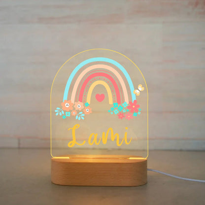 Personalized rainbow and flower LED baby night light with name Lami on wooden base.